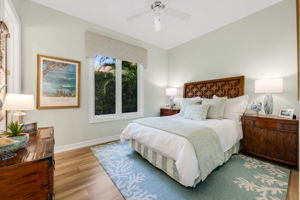 The second guest suite is on the other side of the foyer and has wood floors with a large walk-in closet.