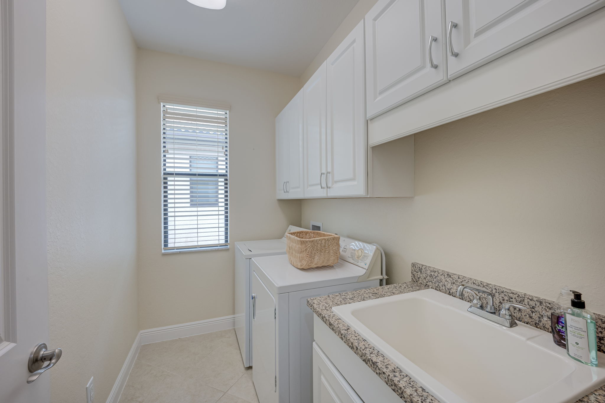Laundry Room with cabinets and sink