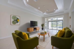 Virtually Staged Living Room with Sliders to Lanai and Pool area  and custom tray ceilings