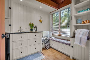 Pool house features bar sink, loft, custom built-ins, built-in speakers & bar fridge. Adjacent to heated outdoor shower!!