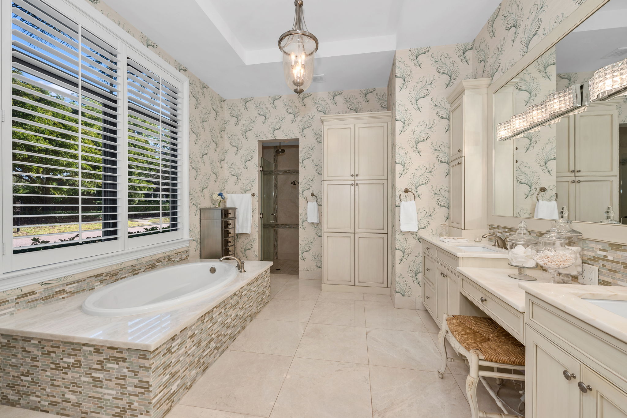 The primary bath has had custom storage cabinets added, with a large, walk-in shower.