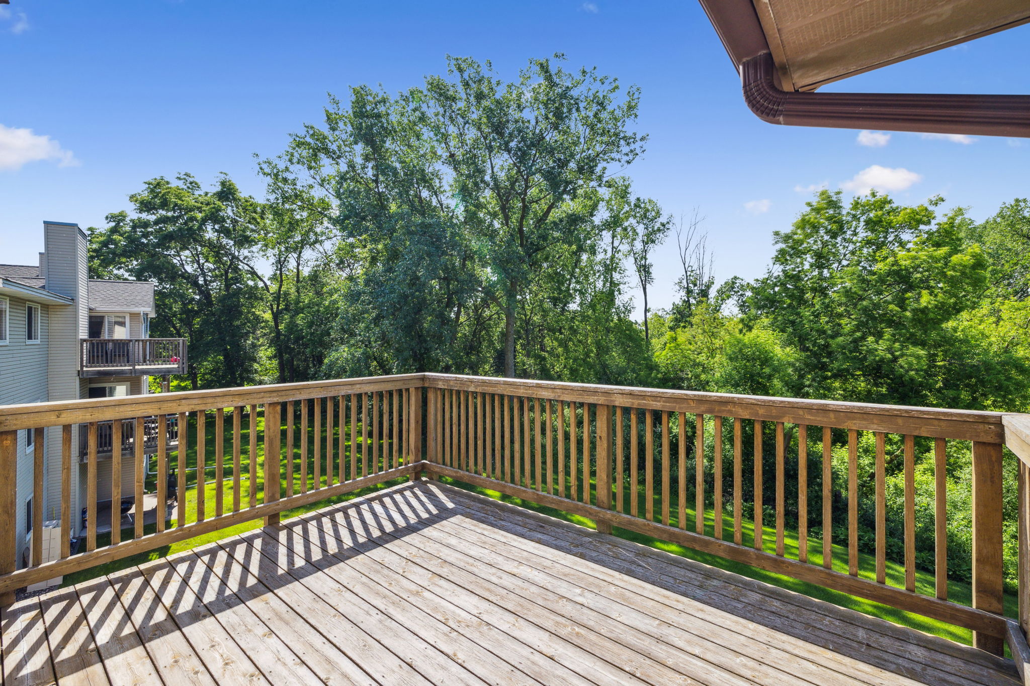 Privacy and tranquility with an upper level unit  with a balcony looking into the trees