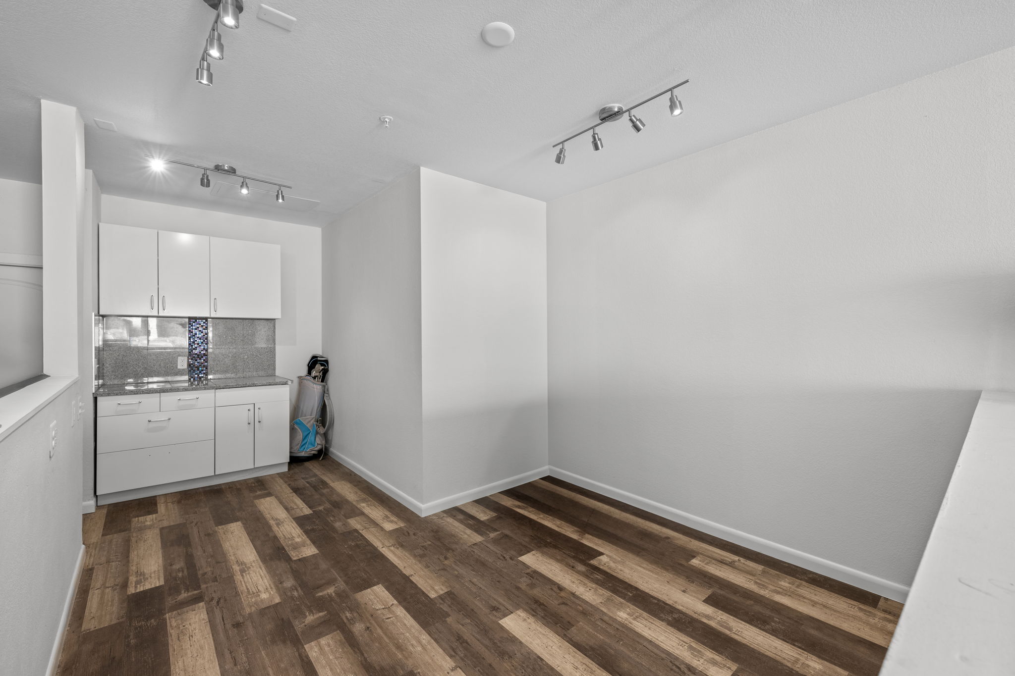 Finished area in garage with track lighting, tons of electrical outlets, cabinet - perfect for working on your hobbies