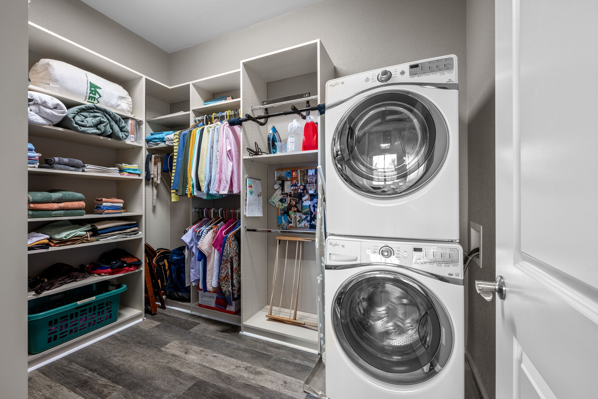 Custom cabinetry in walk in closet with stackable washer & dryer (included)