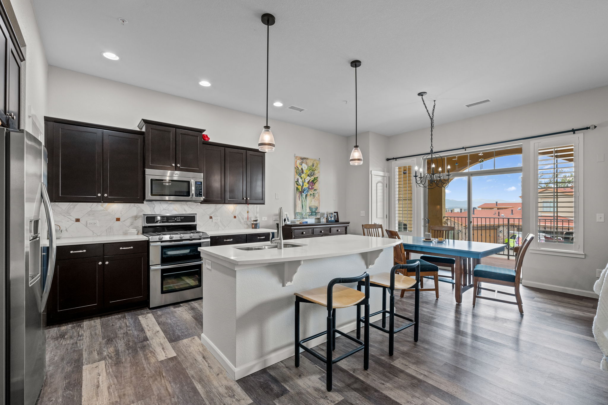 Gourmet kitchen with quartz countertops, upscale lighting