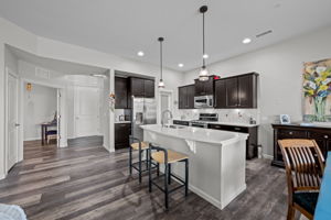 View of Kitchen and back to front door and office