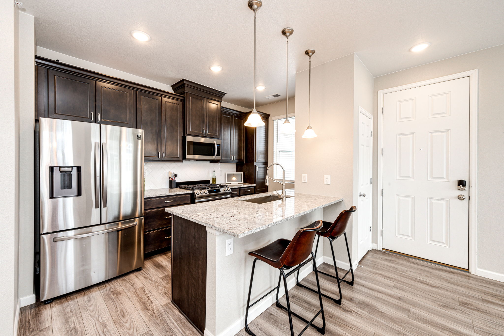 Stainless steel appliances and a breakfast bar