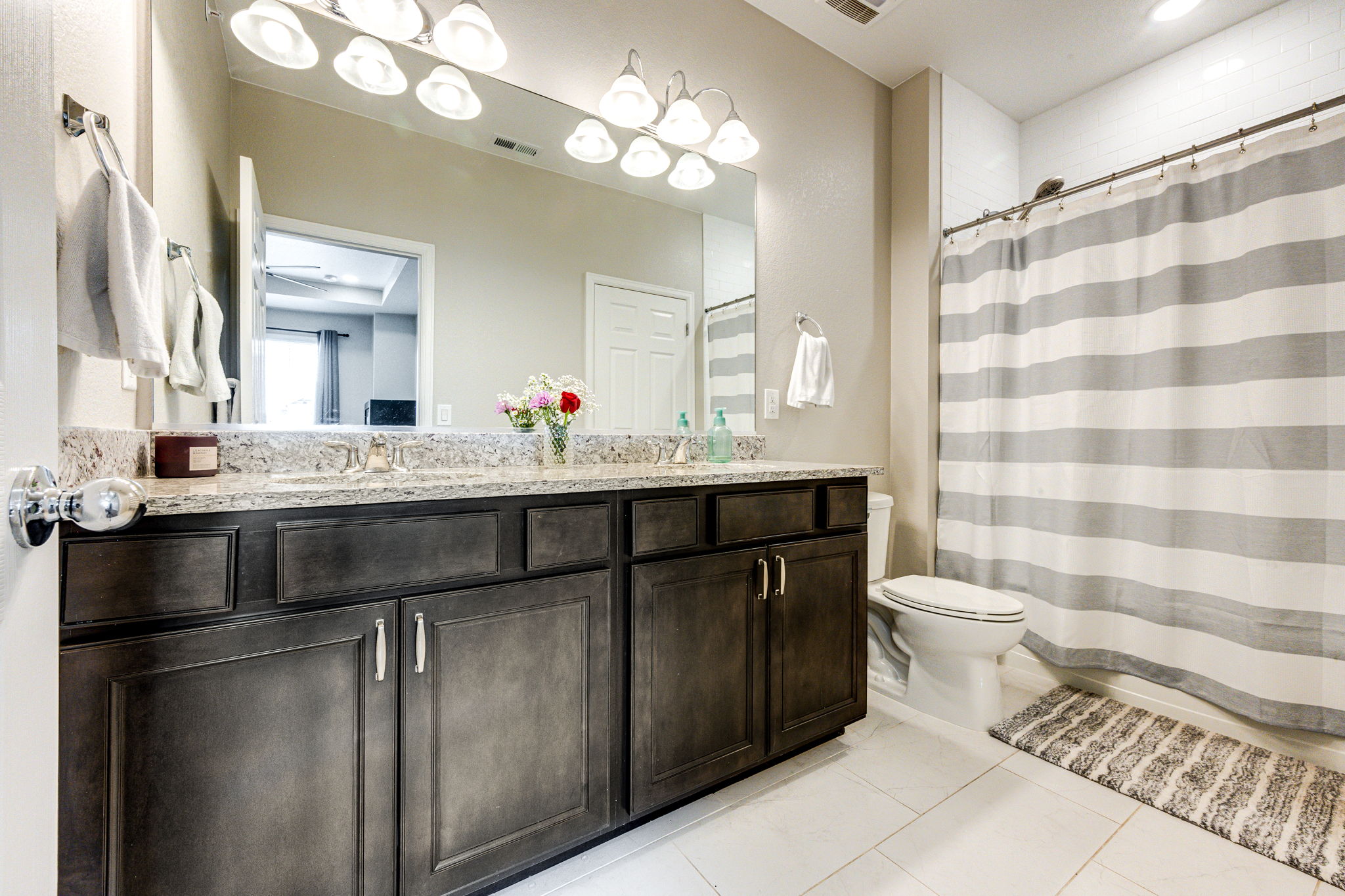 Full bathroom with granite double sinks