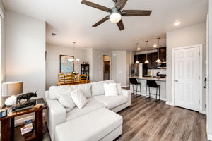 Corner view of the living area into the kitchen & dining area