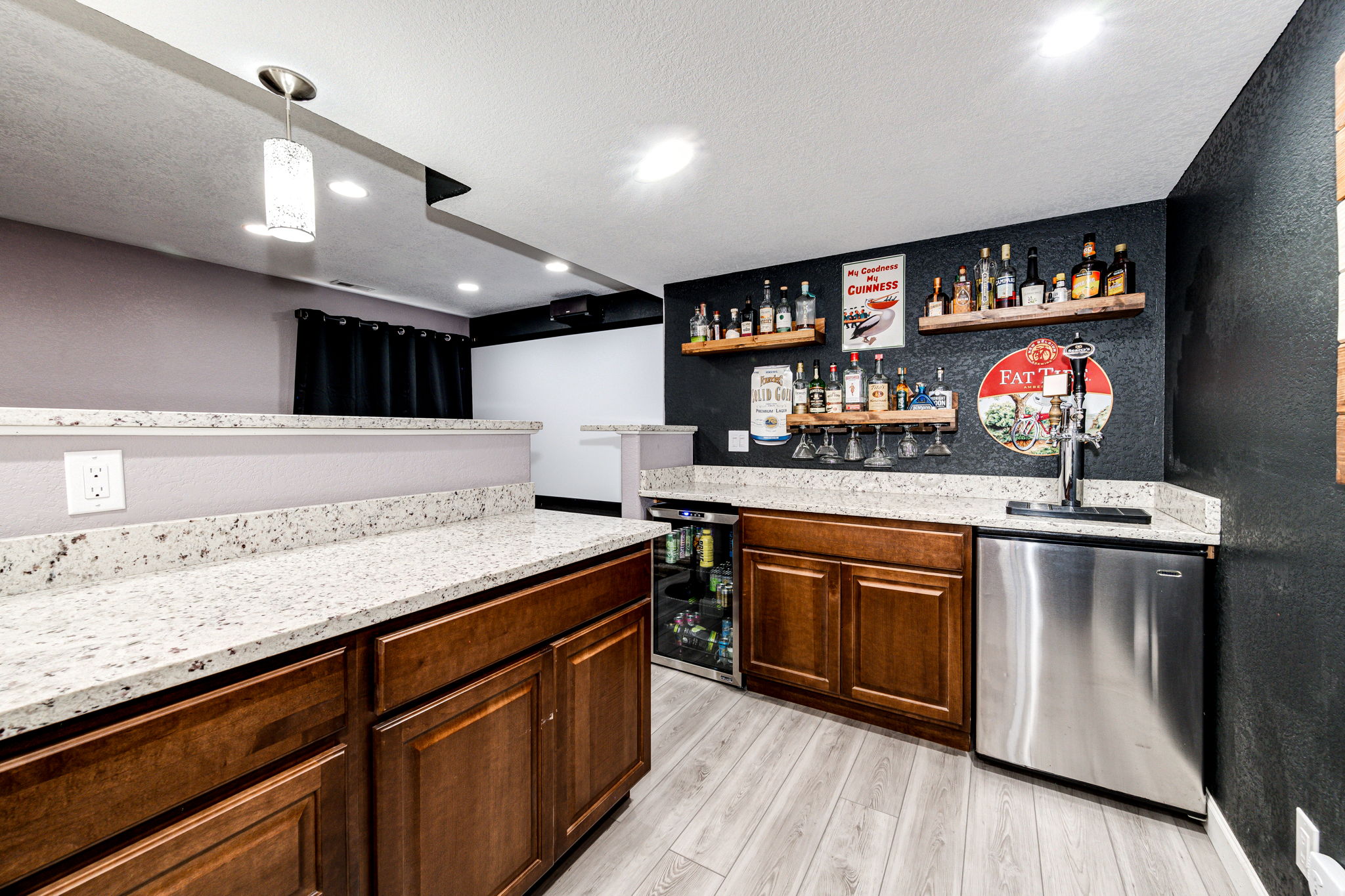 Corner view from the bar area of the kegerator, mini fridge & movie screen!