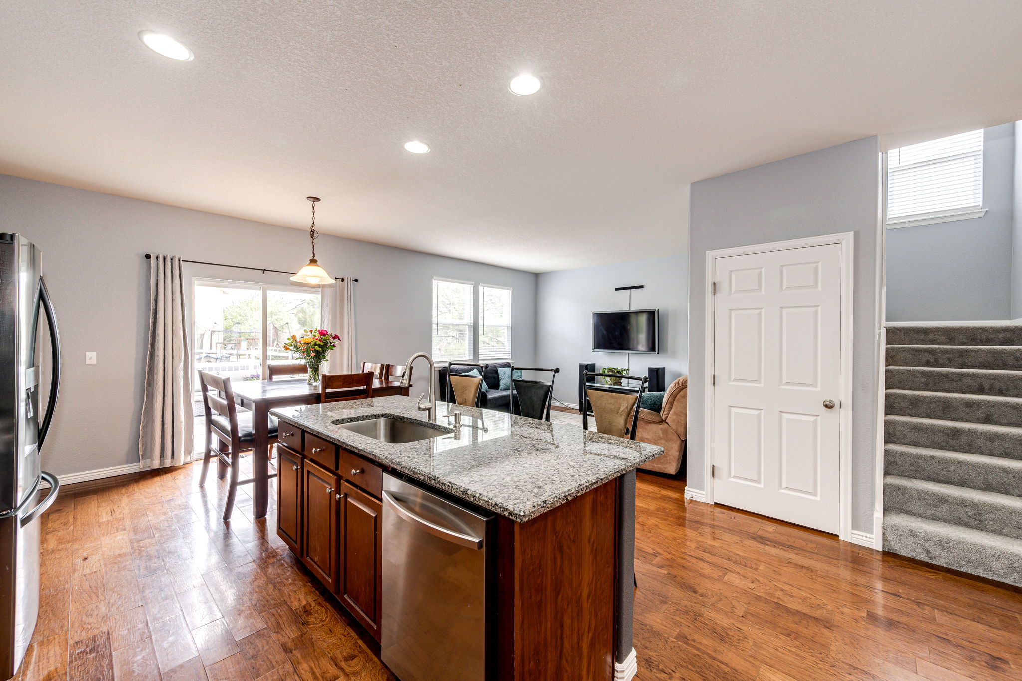 View of the family room and patio doors leading out onto the backyard patio area