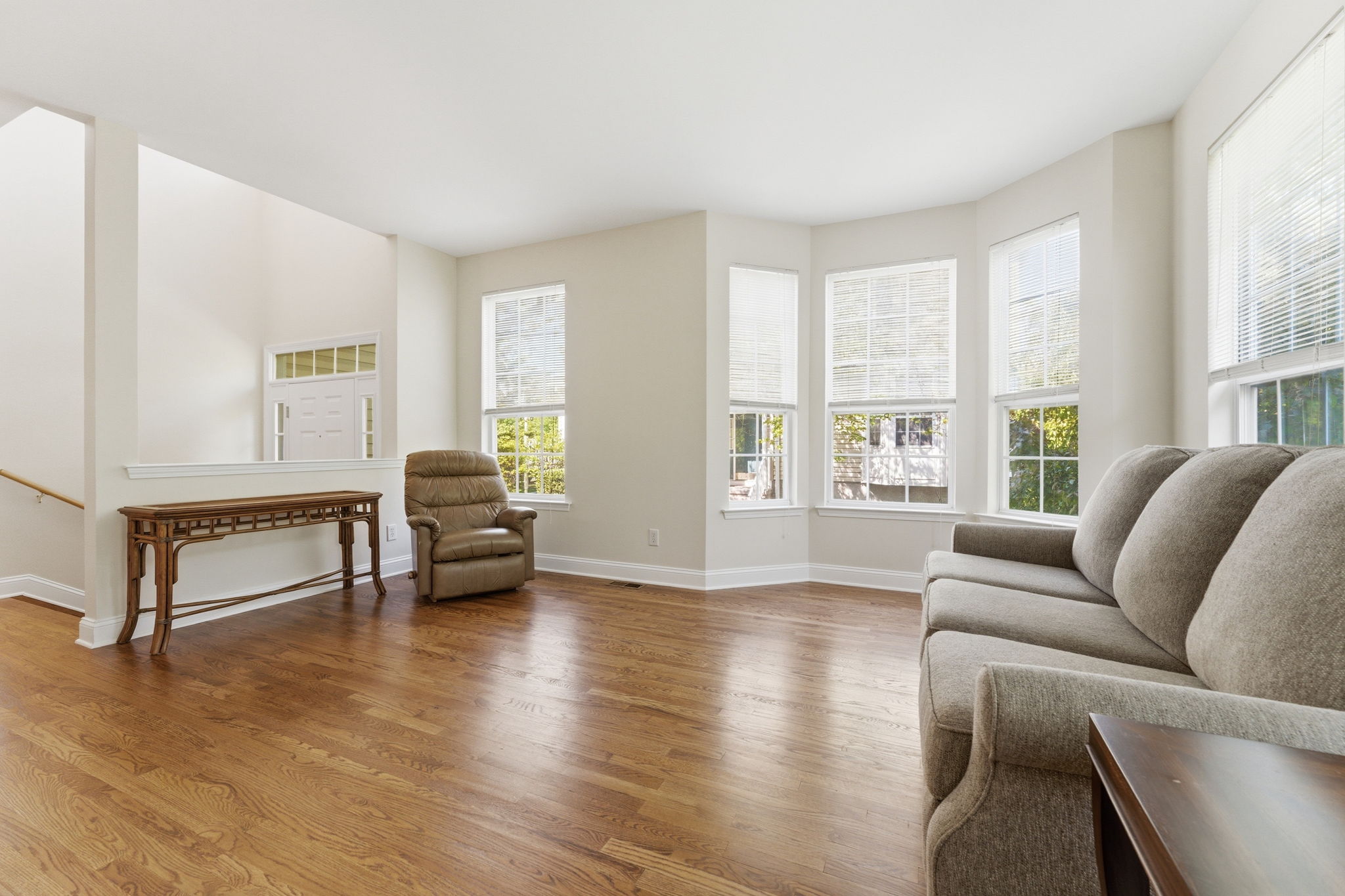 An open-concept layout filled with natural light lends an airy, welcoming feel throughout. Refinished hardwood floors throughout the main level.