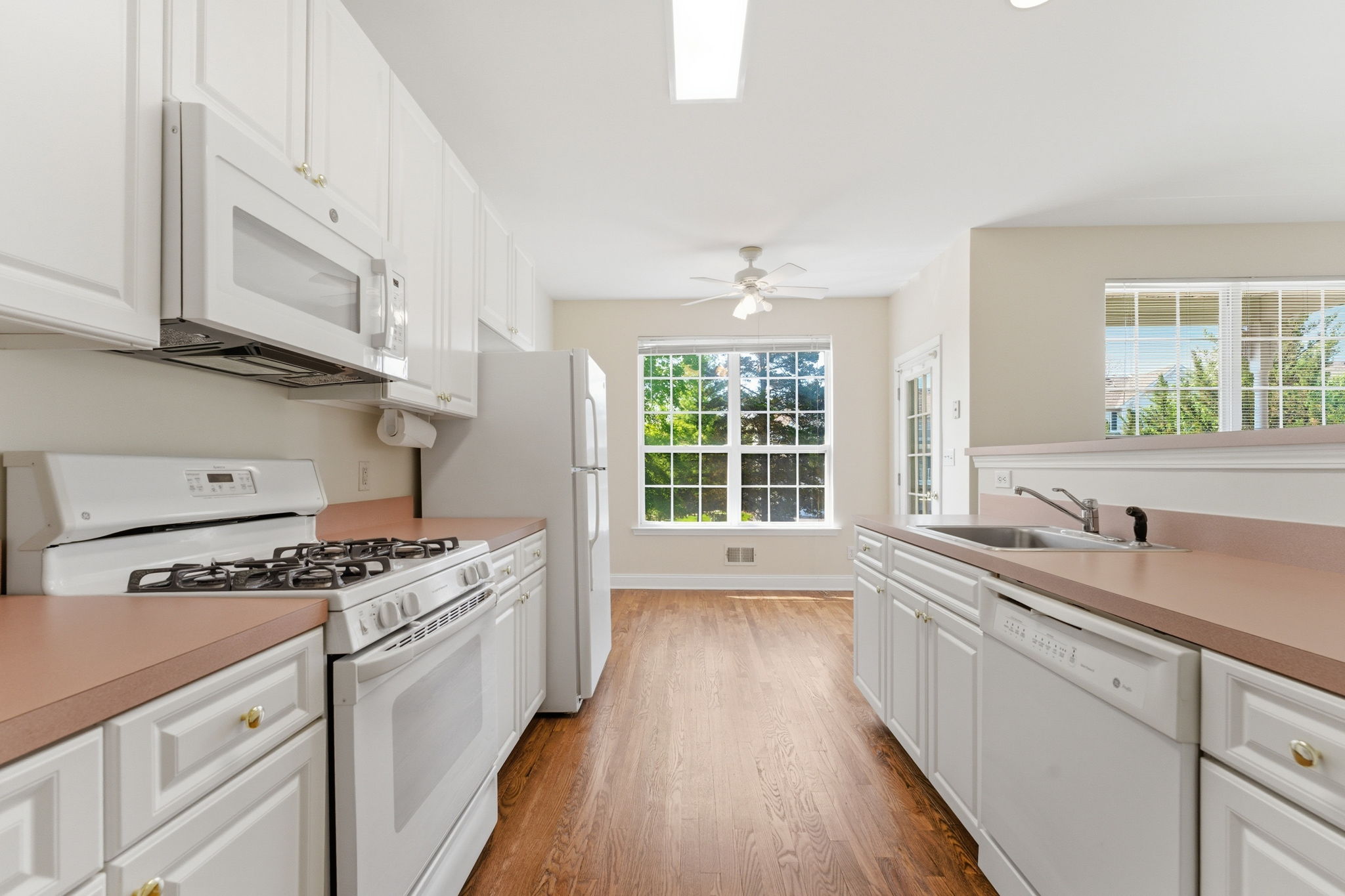 Crisp white cabinetry and white GE appliances.
