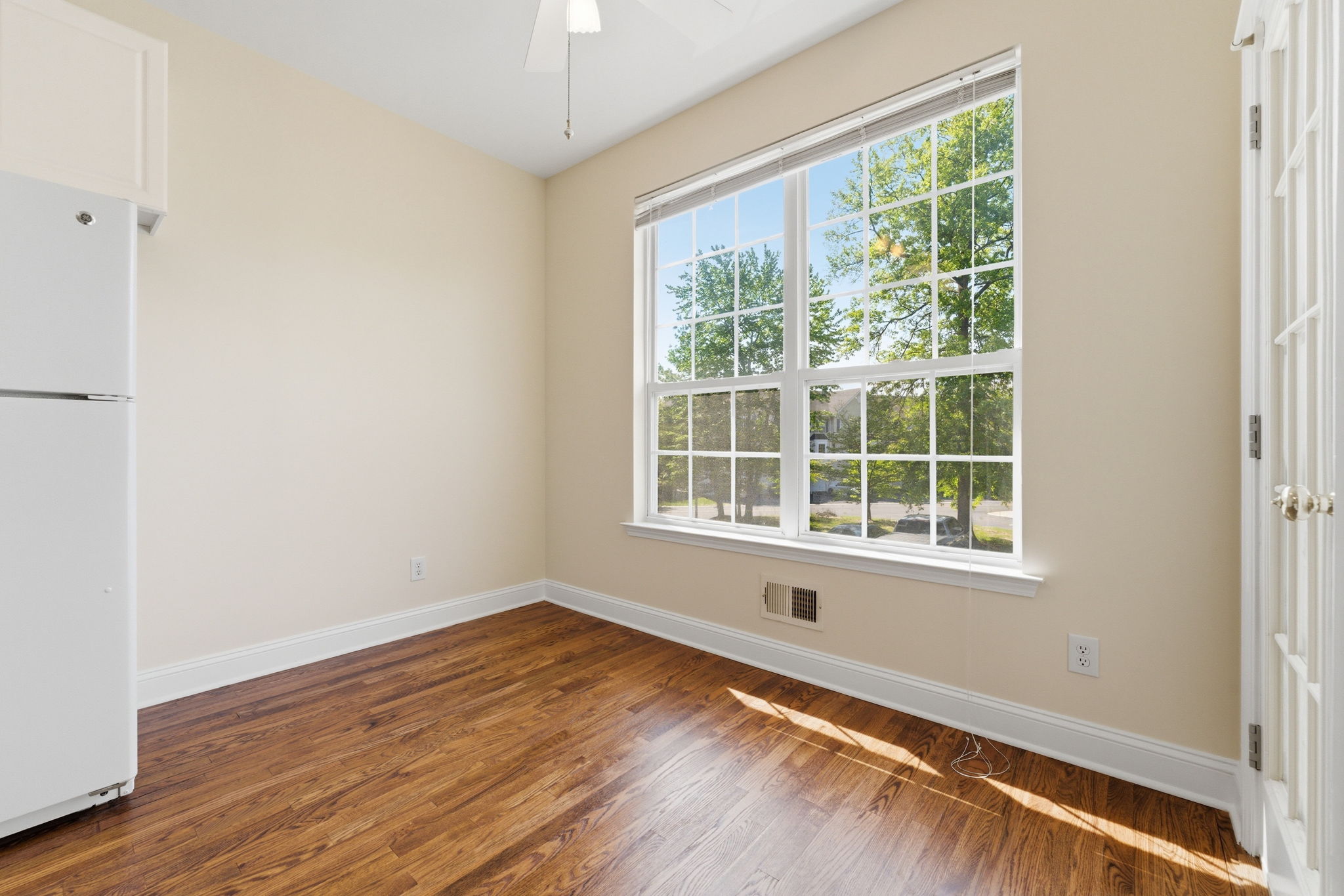 A charming breakfast nook with deck access opens to the inviting family room.