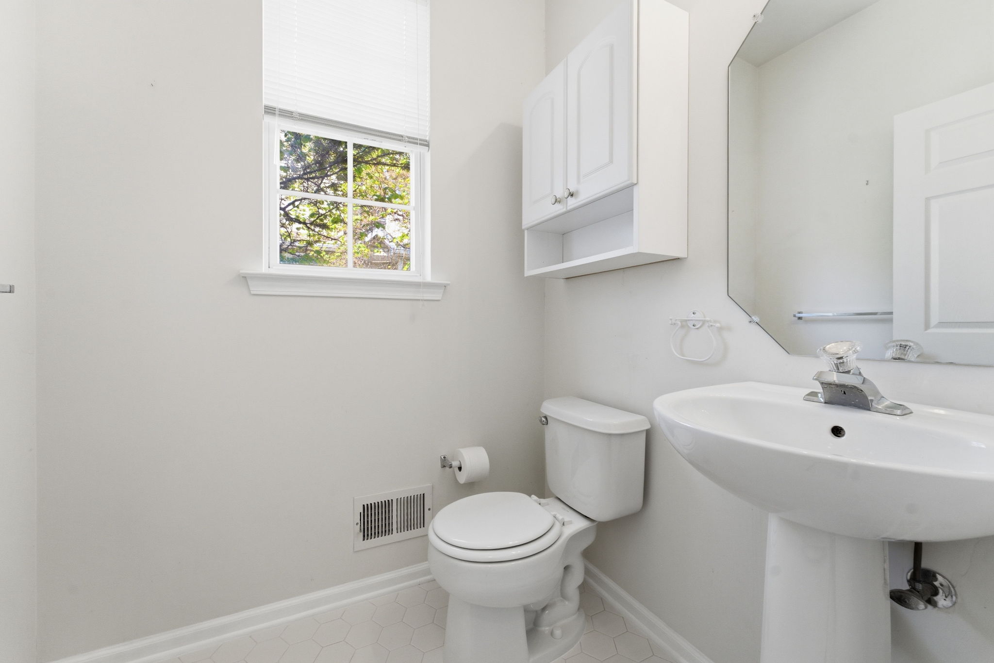 Wall-mounted cabinet, pedestal sink, tile floor