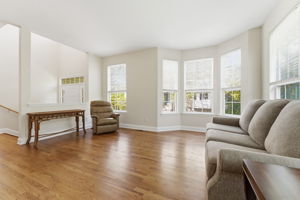 An open-concept layout filled with natural light lends an airy, welcoming feel throughout. Refinished hardwood floors throughout the main level.