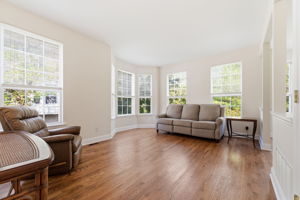 An open-concept layout filled with natural light lends an airy, welcoming feel throughout. Refinished hardwood floors throughout the main level.