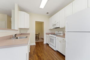Recessed lighting, ceiling fan and refinished hardwood floor.