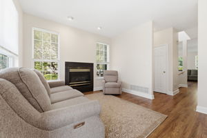 Family room features recessed lighting, a gas fireplace and refinished hardwood floor.
