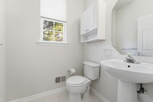 Wall-mounted cabinet, pedestal sink, tile floor