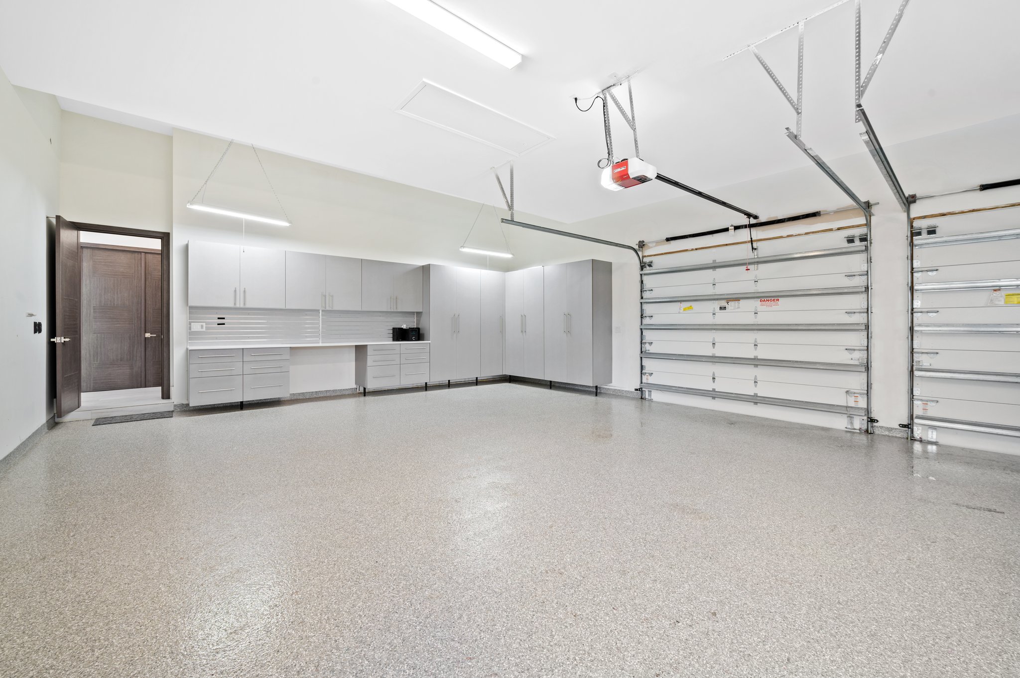 Garage - Epoxy Floors, 12ft Impact Door, Custom Cabinetry Plus Workshop