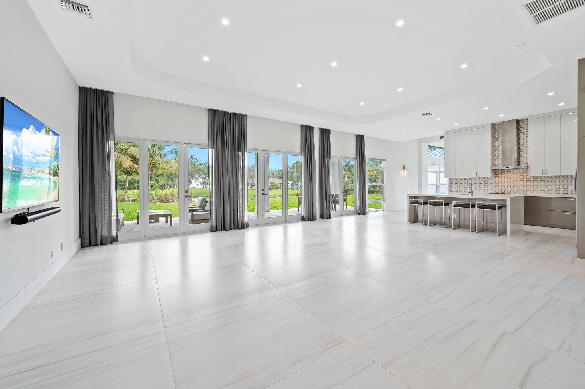 Grand Great Room Living/Dining/Kitchen with 48” x 48” porcelain tile flooring