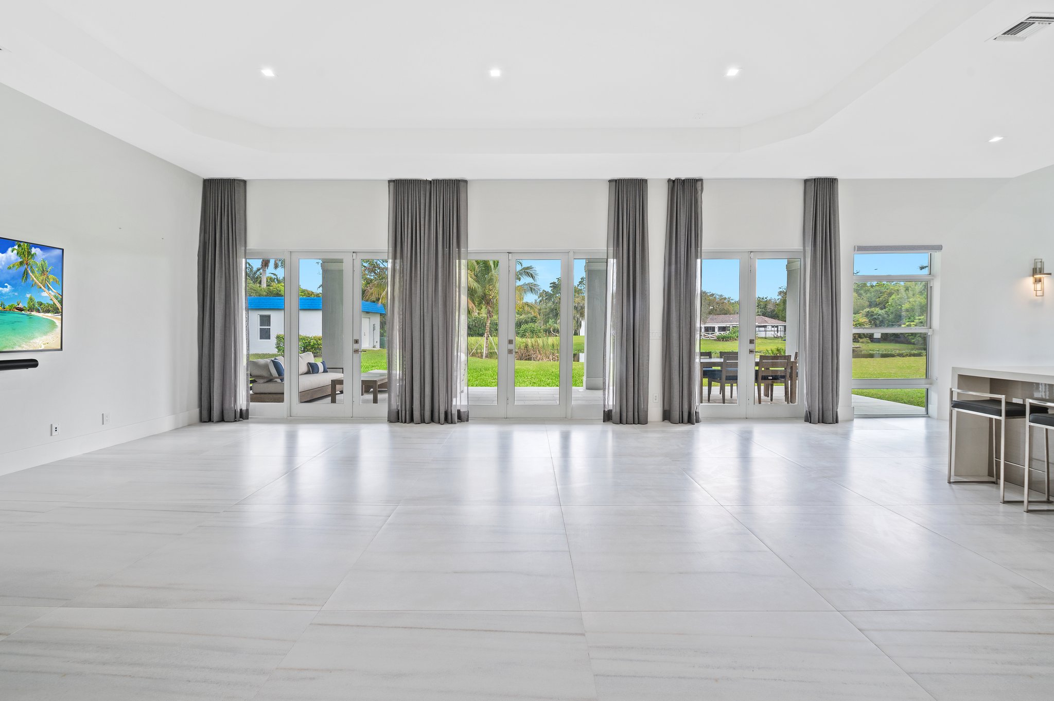 Grand Great Room has 3 sets of French Doors that lead to Covered Marble Patio