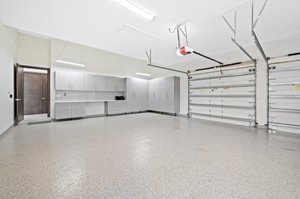 Garage - Epoxy Floors, 12ft Impact Door, Custom Cabinetry Plus Workshop