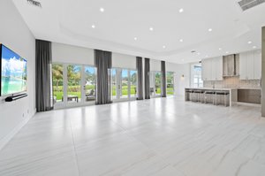 Grand Great Room Living/Dining/Kitchen with 48” x 48” porcelain tile flooring