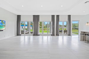 Grand Great Room has 3 sets of French Doors that lead to Covered Marble Patio