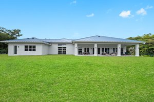 Exterior - Back - Sweeping green space—perfect canvas for resort pool, pickleball or tennis courts, soccer field, or equestrian lifestyle