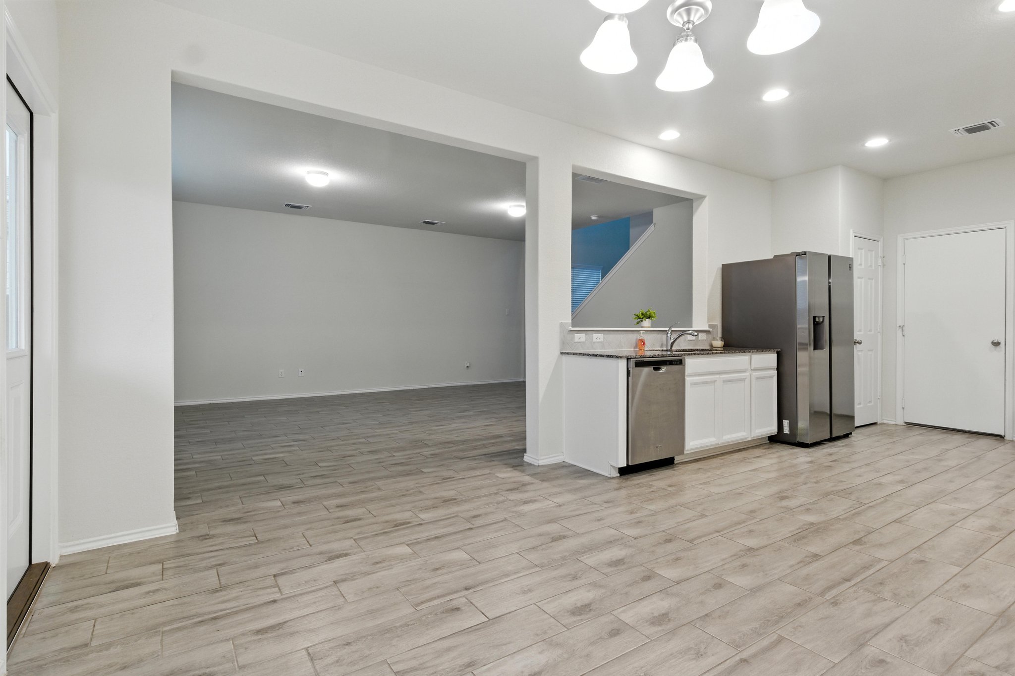 The kitchen also includes a stainless refrigerator.