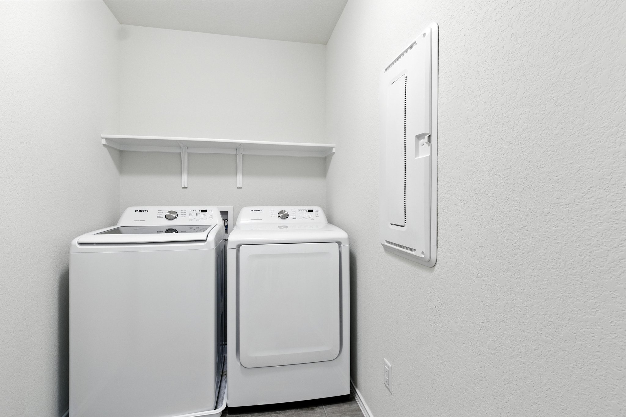 The upstairs laundry room also includes this washer and dryer.