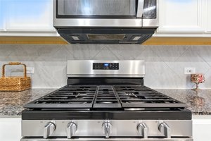 This 5 burner gas stove and built in microwave compliments this awesome kitchen.