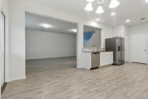 The kitchen also includes a stainless refrigerator.