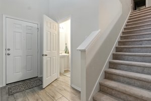 The powder room is discretely located for privacy for family members and guests.
