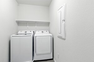 The upstairs laundry room also includes this washer and dryer.