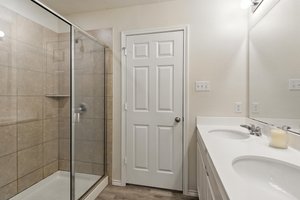 The lavish owner's bath also features a large custom shower.