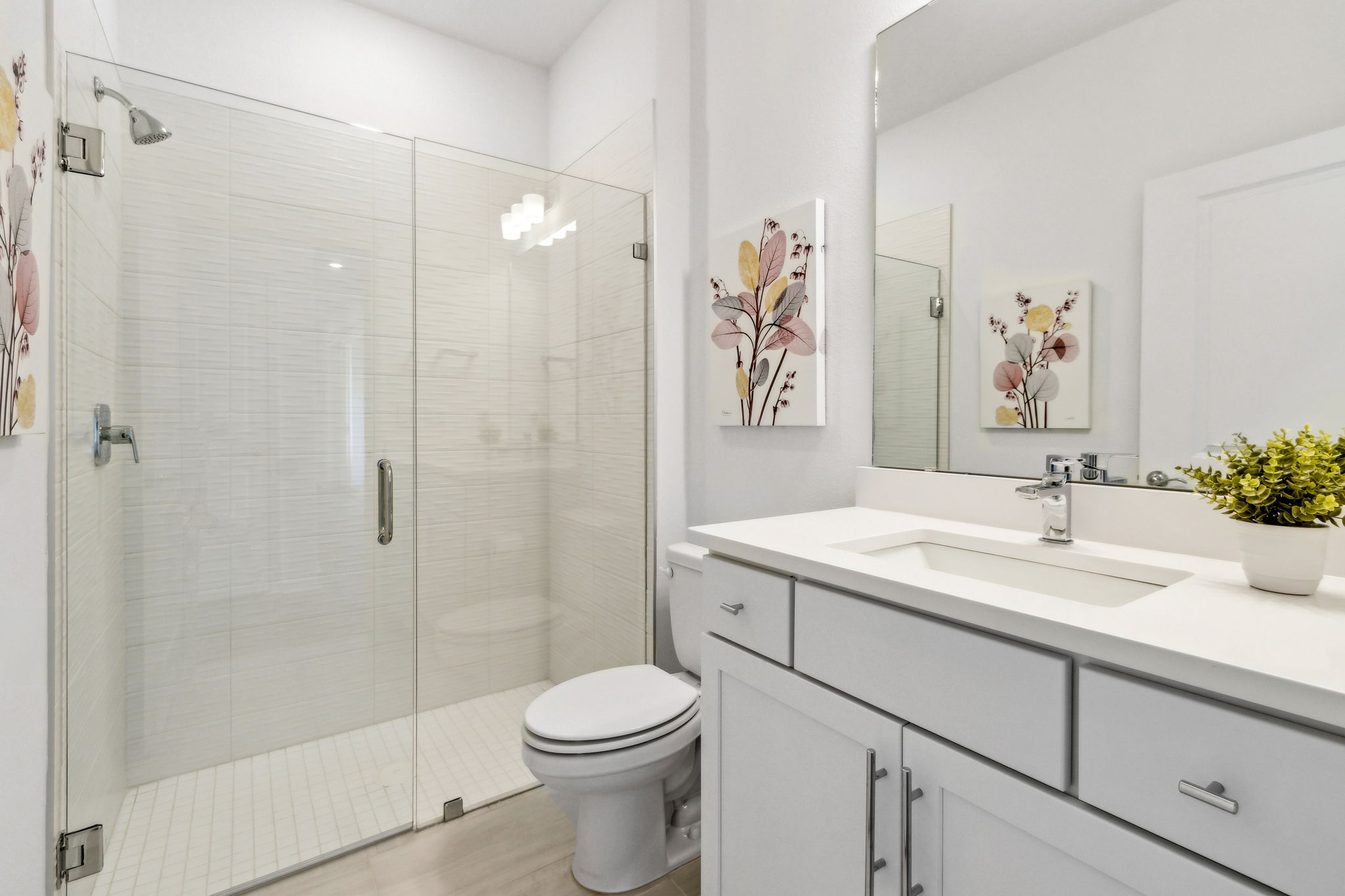 ...as is the guest bath, with sleek frameless shower doors.