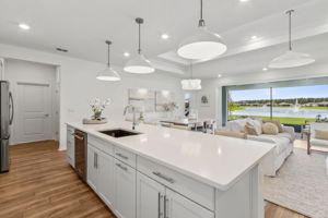 The airy, open-concept design looks out over a picturesque pond.