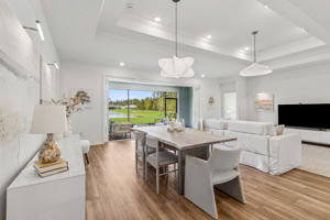 The dining area flows seamlessly from the kitchen ...