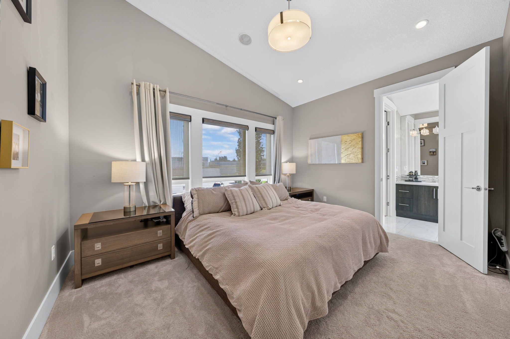 Vaulted primary suite with private ensuite beyond