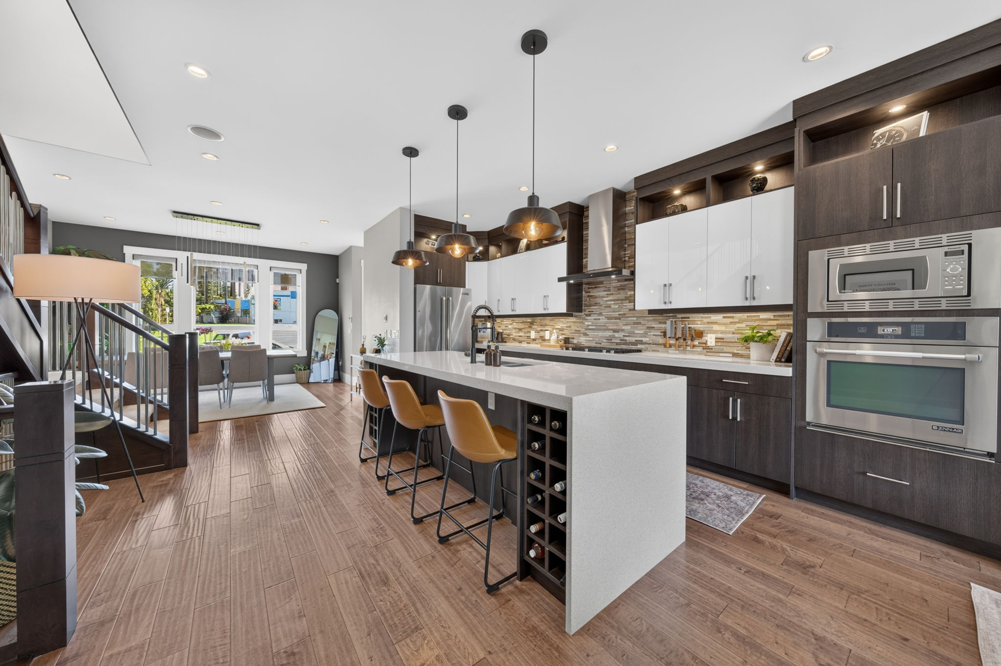 Chef's kitchen with quartz waterfall island and wine storage