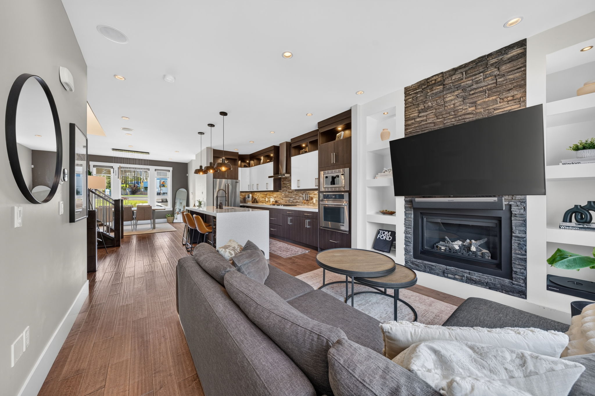 Living room anchored by a stone-faced gas fireplace