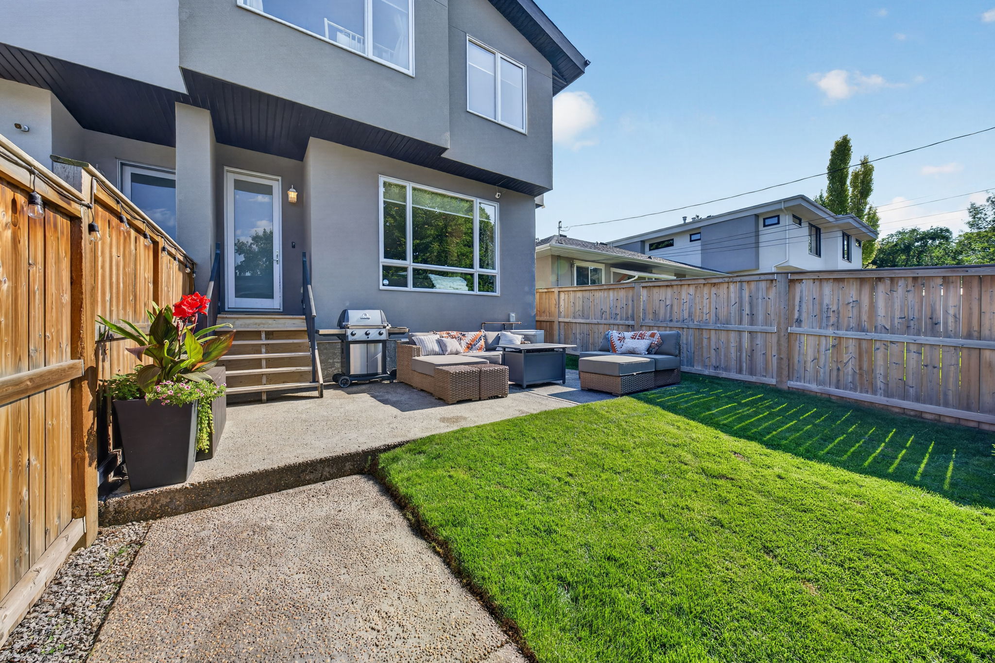 Fenced west-facing yard with a private patio