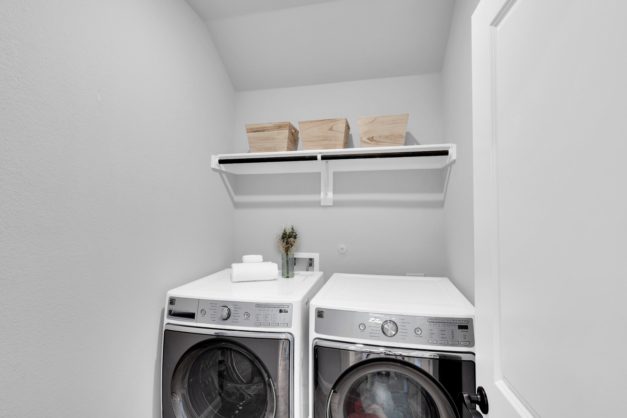 A downstairs laundry room is strategically located and offers ample space for all laundry needs