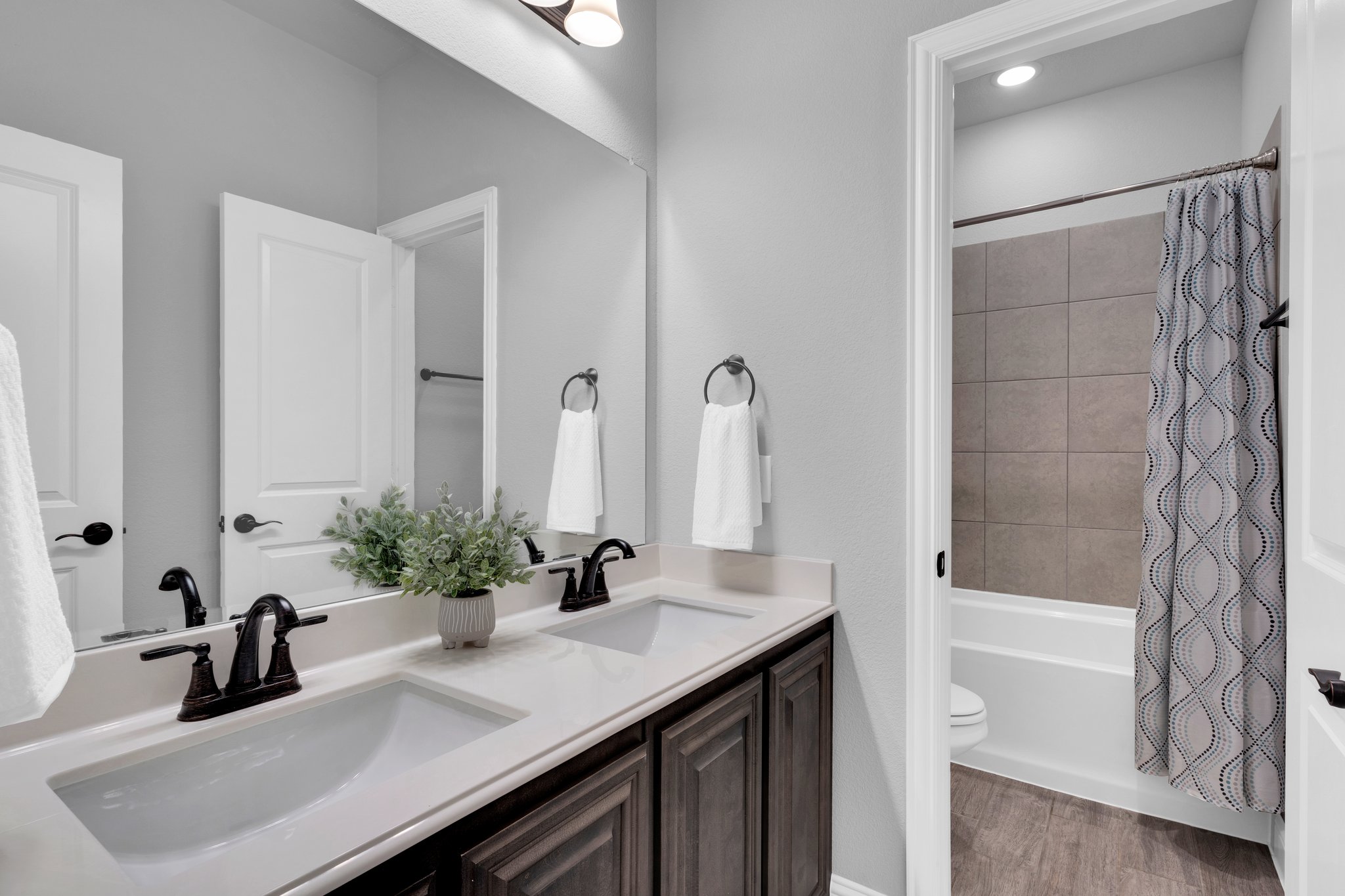 The secondary bedrooms downstairs have sufficient access to a full bath with tiled shower and tub area