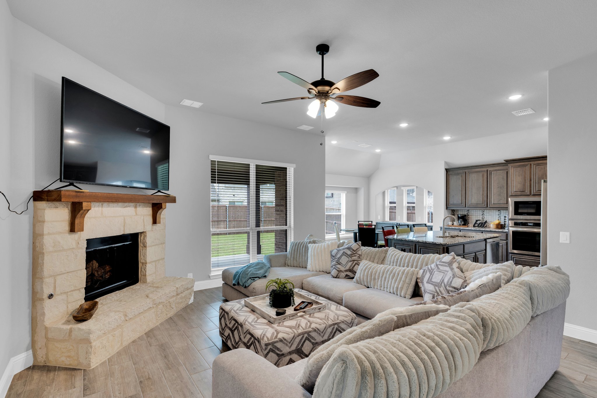 Stunning options such as wood tile floors in downstairs common areas and stone-to-cedar mantel fireplace in the living room enhance the home's appeal