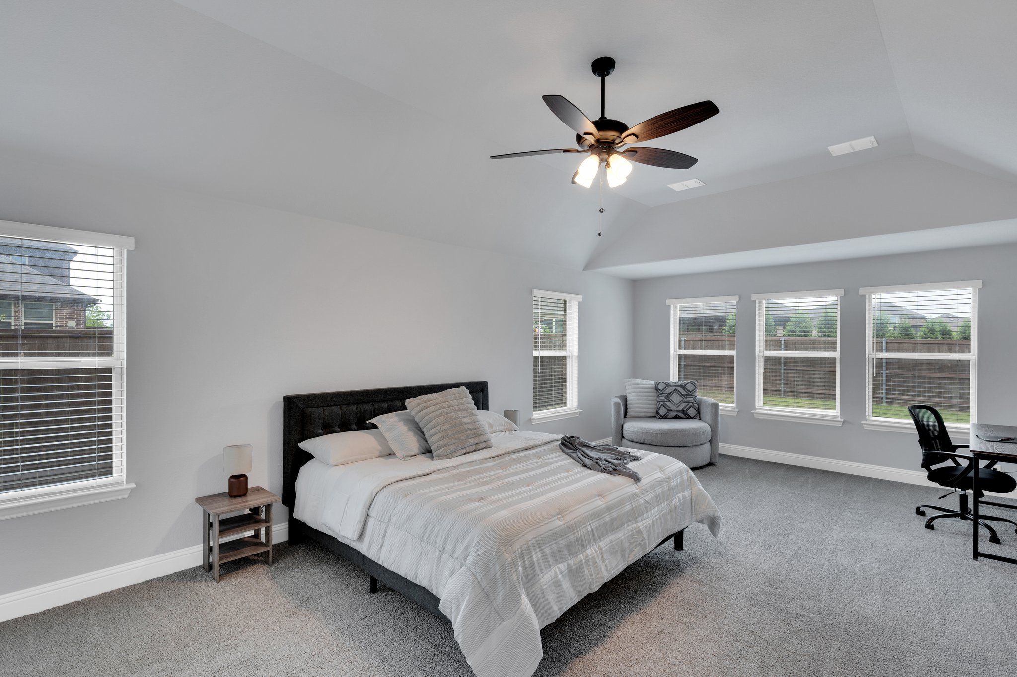 Luxurious oversized primary suite downstairs - bedroom has sufficient room for sitting or office area alongside a king bed