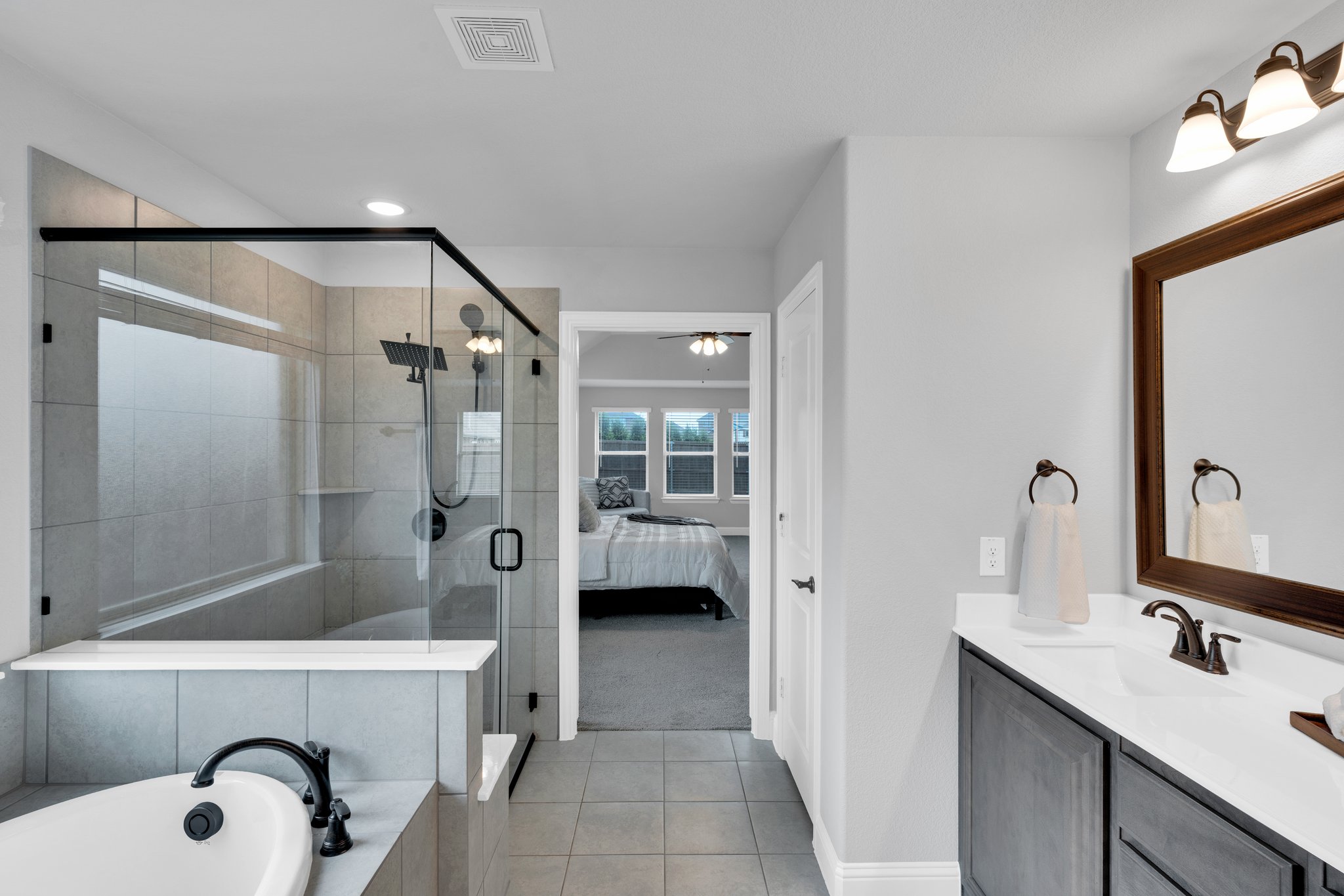 The home is thoughtfully designed with a luxurious oversized primary suite downstairs